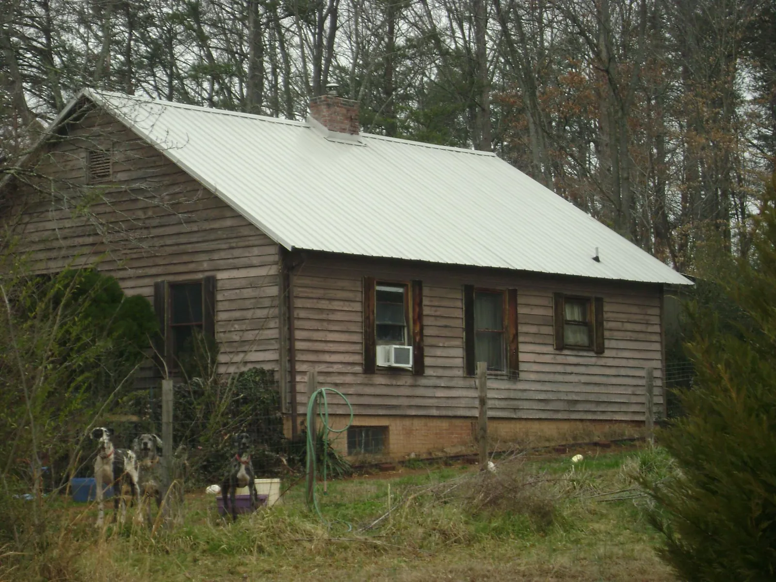 White metal roof on an old wood sided farmhouse, from a Asphalt Shingle Roof Repair job in Garretson